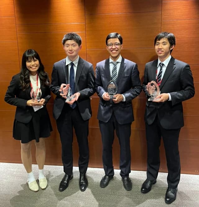 The four person Tokyo Tech team holding their trophies after winning the CFA Institute Research Challenge Japan final